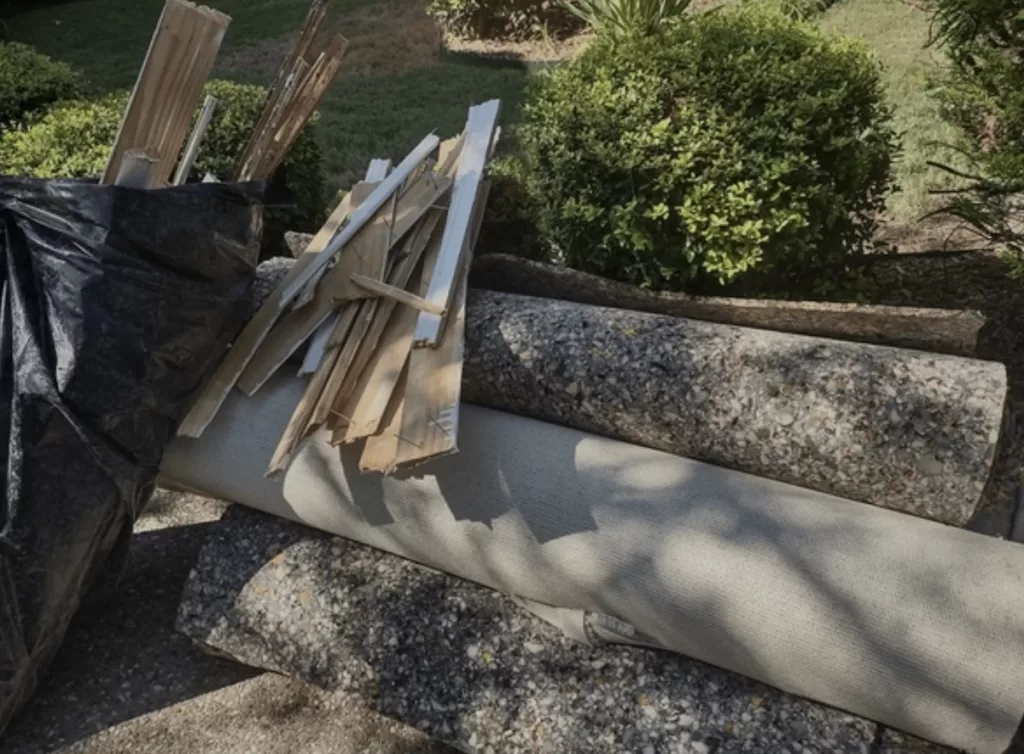 Old carpet and padding rolled up on the curb for junk removal in Woodstock GA