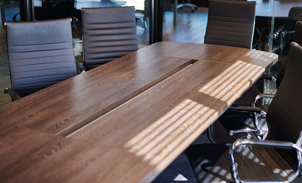 Large conference table ready for removal by Haulin Ass Junk Removal