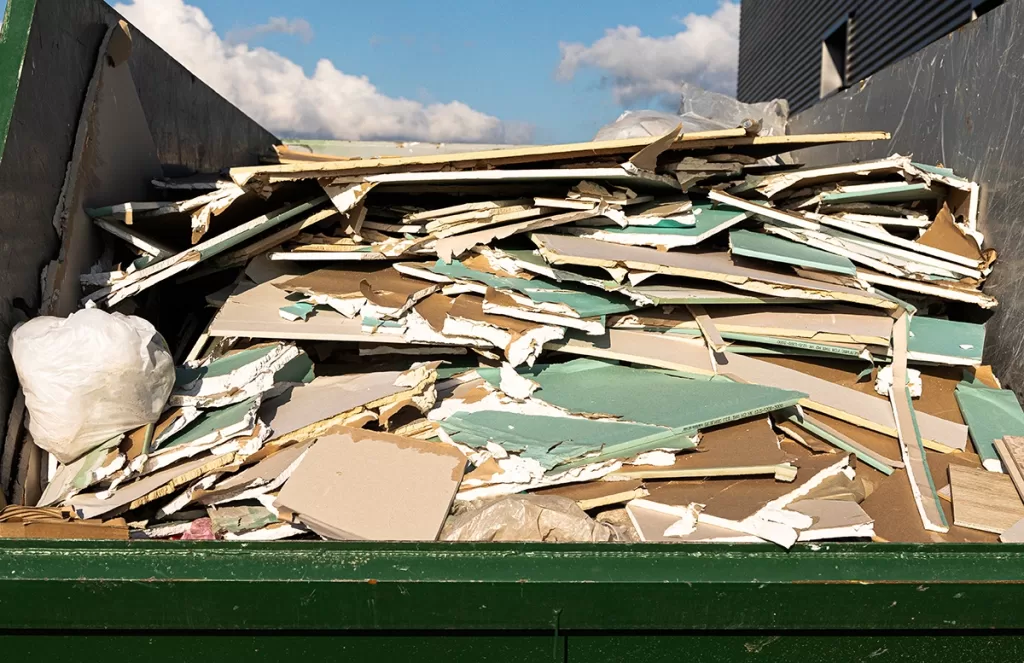 Dump trailer filled with drywall and plaster debris ready for removal