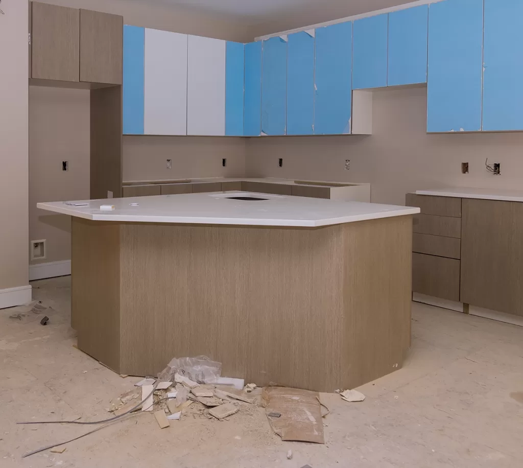 Kitchen under renovation with debris pile on the floor