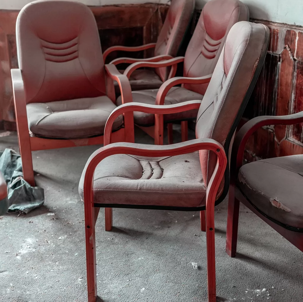 Worn red office chairs ready for junk removal and disposal in Kennesaw, GA